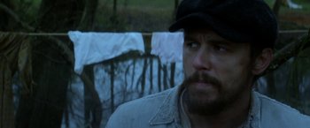 Movie still from “In Dubious Battle” (2016), directed by James Franco – A man with a beard wearing a hat and a jacket; Close Up shot, Over the shoulder angle