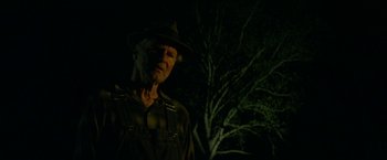 Movie still from “In Dubious Battle” (2016), directed by James Franco – An old man wearing a hat standing next to a tree; Close Up shot, Low angle