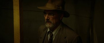 Movie still from “In Dubious Battle” (2016), directed by James Franco – An older man wearing a suit and a hat; Close Up shot, Over the shoulder angle