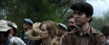 Movie still from “In Dubious Battle” (2016), directed by James Franco – A group of people standing next to each other in a forest; Close Up shot, Low angle