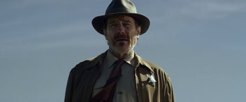 Movie still from “In Dubious Battle” (2016), directed by James Franco – A man wearing a hat and a suit and tie; Close Up shot, Low angle