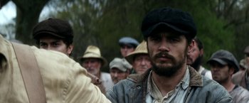 Movie still from “In Dubious Battle” (2016), directed by James Franco – A group of men standing in front of each other; Close Up shot, Low angle