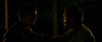 Movie still from “In Dubious Battle” (2016), directed by James Franco – Two men facing one another in the dark; Close Up shot, Over the shoulder angle
