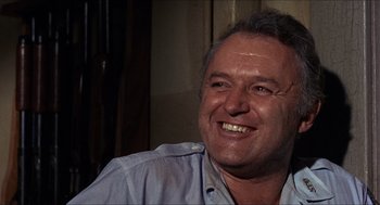 Movie still from “In the Heat of the Night” (1967), directed by Norman Jewison – A person with a smile on their face; Close Up shot, Low angle