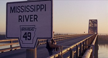 Movie still from “In the Heat of the Night” (1967), directed by Norman Jewison – A man riding a horse down the side of a bridge; Extreme Wide shot, High angle