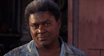 Movie still from “In the Heat of the Night” (1967), directed by Norman Jewison – A person wearing a shirt; Close Up shot, Over the shoulder angle