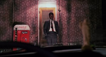 Movie still from “In the Heat of the Night” (1967), directed by Norman Jewison – A man standing in front of a brick building; Wide shot, Low angle