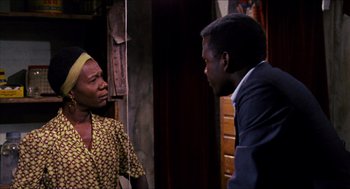 Movie still from “In the Heat of the Night” (1967), directed by Norman Jewison – A man and a woman talking to each other; Medium shot, Over the shoulder angle