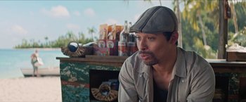 Movie still from “In the Heights” (2021), directed by Jon M. Chu – A person wearing a hat; Close Up shot, Over the shoulder angle