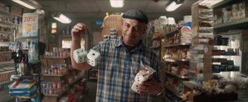 Movie still from “In the Heights” (2021), directed by Jon M. Chu – A man holding a pair of dice in his hands; Medium shot, Low angle