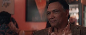 Movie still from “In the Heights” (2021), directed by Jon M. Chu – A person sitting in a chair; Close Up shot, Over the shoulder angle
