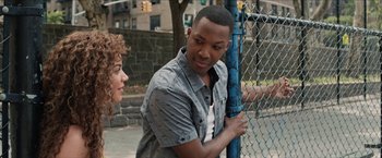 Movie still from “In the Heights” (2021), directed by Jon M. Chu – A man standing next to a woman near a fence; Close Up shot, Over the shoulder angle