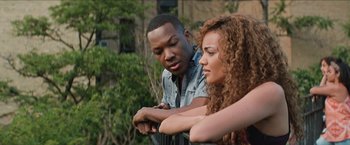 Movie still from “In the Heights” (2021), directed by Jon M. Chu – A man and a woman looking at a watch; Close Up shot, Over the shoulder angle