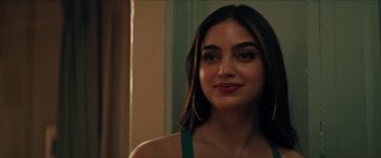 Movie still from “In the Heights” (2021), directed by Jon M. Chu – A person wearing a green dress; Close Up shot, Over the shoulder angle