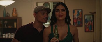 Movie still from “In the Heights” (2021), directed by Jon M. Chu – A man and a woman holding a bottle of beer; Close Up shot, Over the shoulder angle