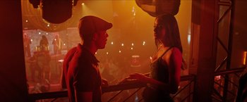Movie still from “In the Heights” (2021), directed by Jon M. Chu – A man and a woman are talking in a bar; Medium shot, Over the shoulder angle