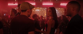 Movie still from “In the Heights” (2021), directed by Jon M. Chu – A man and a woman standing next to each other in front of a crowd of onlookers; Medium shot, Over the shoulder angle