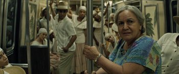 Movie still from “In the Heights” (2021), directed by Jon M. Chu – A group of people standing on a subway train; Close Up shot, Over the shoulder angle