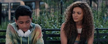 Movie still from “In the Heights” (2021), directed by Jon M. Chu – A woman sitting on a bench next to a man; Close Up shot, Over the shoulder angle