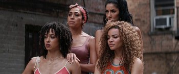 Movie still from “In the Heights” (2021), directed by Jon M. Chu – A group of women standing next to each other; Close Up shot, Low angle