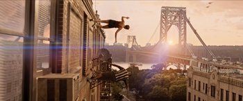 Movie still from “In the Heights” (2021), directed by Jon M. Chu – A man diving into the water from a building; Wide shot, Low angle