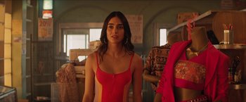Movie still from “In the Heights” (2021), directed by Jon M. Chu – A woman in a red and yellow dress; Medium shot, Over the shoulder angle