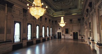 Movie still from “In the Loop” (2009), directed by Armando Iannucci – A large room with a large chandelier in the center of the room; Extreme Wide shot, High angle
