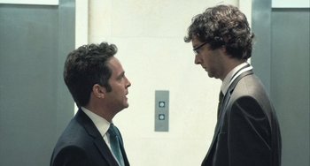 Movie still from “In the Loop” (2009), directed by Armando Iannucci – A couple of men standing next to each other; Medium shot, Low angle