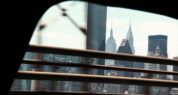 Movie still from “In the Loop” (2009), directed by Armando Iannucci – A view of a city skyline from a bridge; Wide shot, Over the shoulder angle