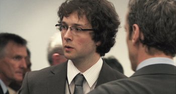 Movie still from “In the Loop” (2009), directed by Armando Iannucci – A man in a suit and tie talking to another man in a suit; Close Up shot, Over the shoulder angle