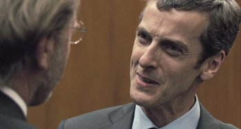 Movie still from “In the Loop” (2009), directed by Armando Iannucci – A person wearing a suit and tie; Close Up shot, Over the shoulder angle