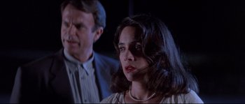 Movie still from “In the Mouth of Madness” (1994), directed by John Carpenter – A man and a woman are looking at something; Close Up shot, Low angle