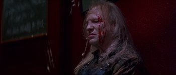 Movie still from “In the Mouth of Madness” (1994), directed by John Carpenter – A man with blood dripping down his face; Close Up shot, Low angle