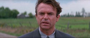 Movie still from “In the Mouth of Madness” (1994), directed by John Carpenter – A person wearing a suit and tie; Close Up shot, Over the shoulder angle