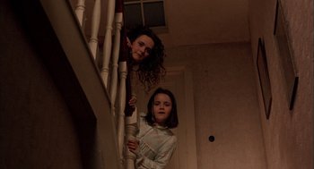 Movie still from “In the Name of the Father” (1993), directed by Jim Sheridan – Two young girls standing at the top of a staircase; Medium shot, Low angle