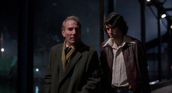 Movie still from “In the Name of the Father” (1993), directed by Jim Sheridan – A man and a woman standing next to each other; Medium shot, Over the shoulder angle