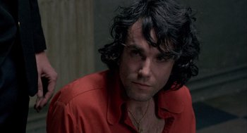 Movie still from “In the Name of the Father” (1993), directed by Jim Sheridan – A person wearing a red shirt; Close Up shot, Over the shoulder angle