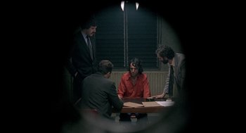 Movie still from “In the Name of the Father” (1993), directed by Jim Sheridan – A group of men sitting around a table; Medium shot, High angle