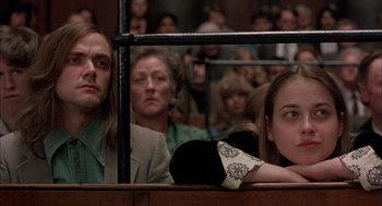 Movie still from “In the Name of the Father” (1993), directed by Jim Sheridan – A group of people sitting in a courtroom; Medium shot, Low angle