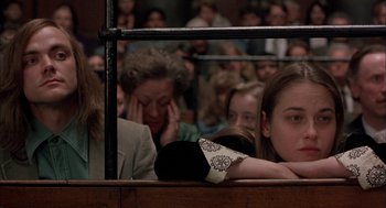 Movie still from “In the Name of the Father” (1993), directed by Jim Sheridan – A group of people sitting in front of an audience; Medium shot, High angle