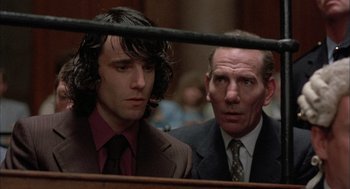 Movie still from “In the Name of the Father” (1993), directed by Jim Sheridan – Two men in suits and ties in front of a judge; Close Up shot, Over the shoulder angle