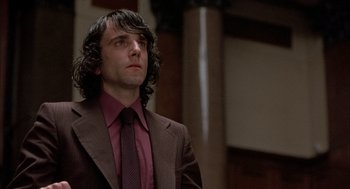 Movie still from “In the Name of the Father” (1993), directed by Jim Sheridan – A man in a brown suit and a red tie; Close Up shot, Low angle