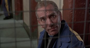 Movie still from “In the Name of the Father” (1993), directed by Jim Sheridan – An older man looking out of a window; Close Up shot, Low angle