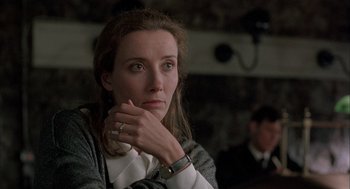 Movie still from “In the Name of the Father” (1993), directed by Jim Sheridan – A person sitting with their hand on her chin; Close Up shot, Over the shoulder angle