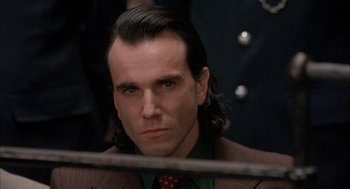 Movie still from “In the Name of the Father” (1993), directed by Jim Sheridan – A person wearing a suit and tie; Close Up shot, Low angle