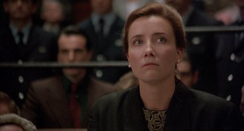 Movie still from “In the Name of the Father” (1993), directed by Jim Sheridan – A woman sitting in front of a group of people in a courtroom; Close Up shot, Low angle