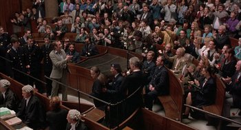 Movie still from “In the Name of the Father” (1993), directed by Jim Sheridan – A group of people sitting in a courtroom; Wide shot, High angle
