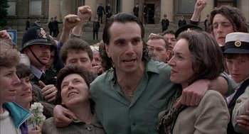 Movie still from “In the Name of the Father” (1993), directed by Jim Sheridan – A group of people that are standing in the street; Close Up shot, High angle