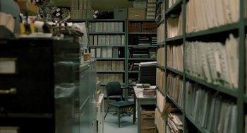 Movie still from “Incendies” (2010), directed by Denis Villeneuve – A room filled with lots of shelves filled with papers; Wide shot, High angle