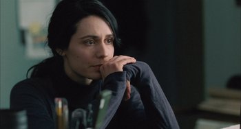 Movie still from “Incendies” (2010), directed by Denis Villeneuve – A woman sitting at a table with her hand on her chin; Close Up shot, Over the shoulder angle